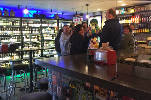 Lucky Louie’s Beer & Wieners’ regular enjoying a cold craft beer and hot dogs.