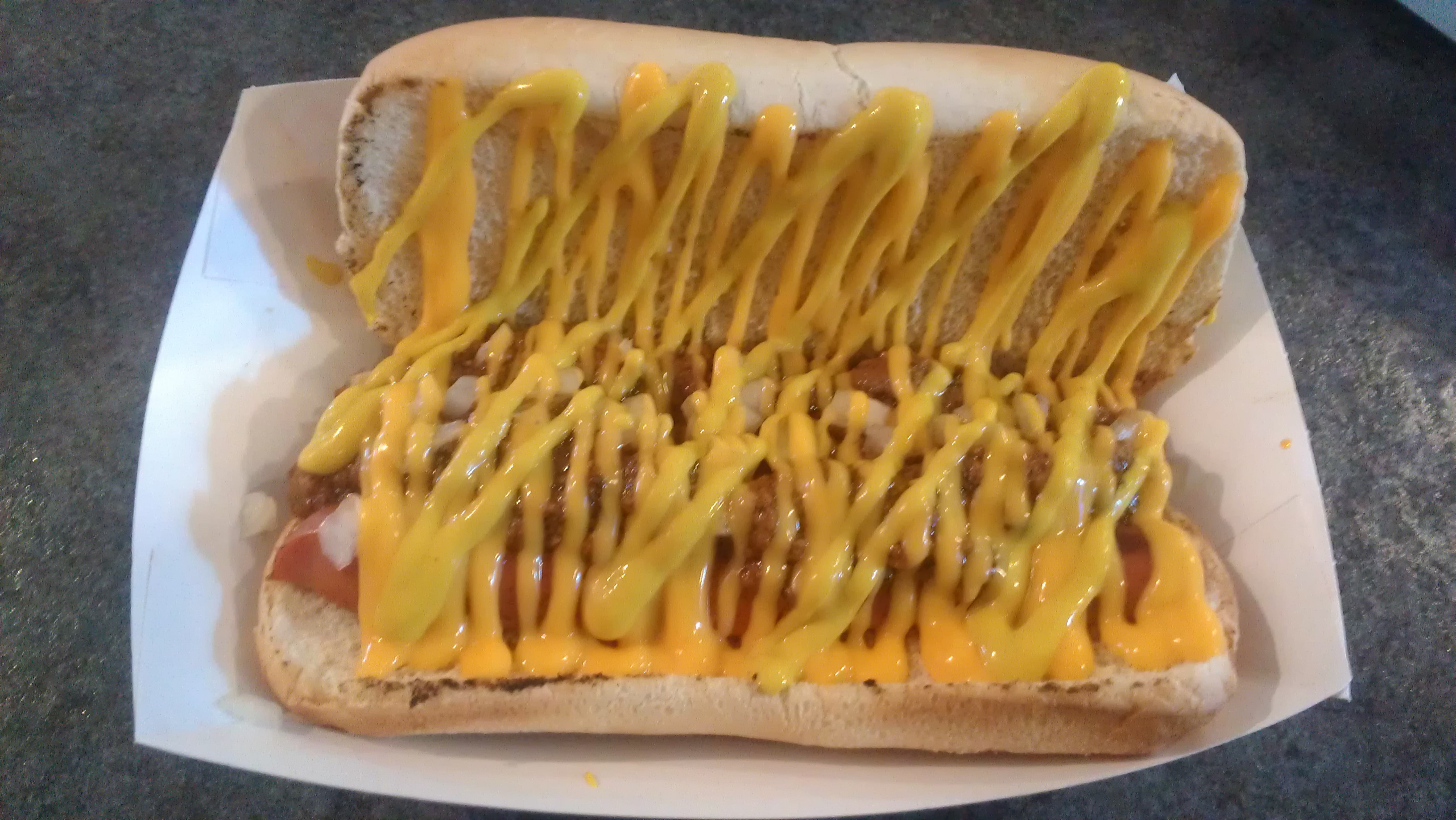 Pictured here:  An Erie Favorite! Judy’s Ash Street Greek Wiener featuring Lower East Side SPICY Greek Sauce, Onion, Mustard and Cheese Sauce.